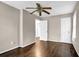 Neutral bedroom with hardwood floors, fan, and two doors leading to other rooms at 91 Tatum St, Marietta, GA 30060