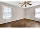 Bedroom showcasing hardwood floors, ceiling fan, and natural light streaming through the windows at 91 Tatum St, Marietta, GA 30060