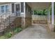 Close-up of the carport with stone foundation and view of the front porch at 91 Tatum St, Marietta, GA 30060