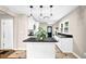 Kitchen with an island, black countertops, white cabinets, and stainless steel appliances at 91 Tatum St, Marietta, GA 30060