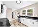 Bright kitchen featuring black countertops, white cabinetry, and stainless steel appliances at 91 Tatum St, Marietta, GA 30060