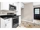 This kitchen features stainless steel appliances, white cabinets, and dark granite countertops at 91 Tatum St, Marietta, GA 30060