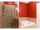 Bathroom showcases tiled walk-in shower and soaking tub at 1190 Hardee Ne St, Atlanta, GA 30307