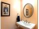 Powder room with a pedestal sink and framed artwork at 1190 Hardee Ne St, Atlanta, GA 30307