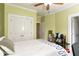 Bedroom features light green walls, ceiling fan, and a double door closet at 1190 Hardee Ne St, Atlanta, GA 30307