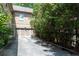 Exterior view shows a two-car garage and driveway surrounded by mature trees and green foliage at 1190 Hardee Ne St, Atlanta, GA 30307