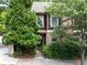 Charming two-story townhome featuring a brick and shingle facade with mature trees and landscaping at 1190 Hardee Ne St, Atlanta, GA 30307
