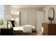 Stylish bedroom featuring patterned wallpaper, a cozy bed, and a wooden dresser at 1817 Holmsey Se Cir, Conyers, GA 30094