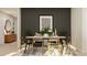 Stylized dining room featuring a wooden table with seating for six, a decorative rug, and contemporary artwork at 1817 Holmsey Se Cir, Conyers, GA 30094