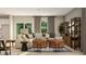 Bright living room with comfortable seating, stylish decor, large windows, and seamless flow to the kitchen at 1817 Holmsey Se Cir, Conyers, GA 30094