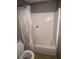 Bathroom featuring a white bathtub with shower curtain and toilet at 3040 Garnet Way, Atlanta, GA 30349
