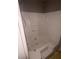 White bathtub with seat and steps, ready for a remodel at 3040 Garnet Way, Atlanta, GA 30349