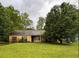 Charming single-story home with a well-maintained lawn and mature trees at 3040 Garnet Way, Atlanta, GA 30349