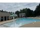 Community swimming pool with lounge chairs, shade structures, and crystal-clear water at 100 Inspiration Ln, Dallas, GA 30157