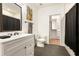 Bright bathroom with a sleek vanity, modern fixtures, and a walk-in closet nearby at 1302 Ladd St, Atlanta, GA 30310