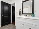 Bathroom sink and vanity with white cabinets, quartz countertops, and black fixtures at 1302 Ladd St, Atlanta, GA 30310