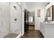 Updated bathroom featuring a glass shower, marble tile and vanity adjacent to the bedroom at 1302 Ladd St, Atlanta, GA 30310