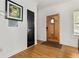 Bright entryway with hardwood floors and a decorative wooden front door at 1302 Ladd St, Atlanta, GA 30310