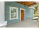 Inviting front porch with a wooden door and a stylish hanging light fixture at 1302 Ladd St, Atlanta, GA 30310
