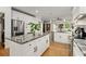 Open kitchen with stainless steel appliances, white cabinets, and a granite island at 1302 Ladd St, Atlanta, GA 30310