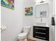 Stylish powder room featuring a vessel sink on a modern vanity and contemporary art at 1302 Ladd St, Atlanta, GA 30310