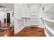 A spacious walk-in closet with custom shelves, hardwood floors, and a view into the main bedroom at 1302 Ladd St, Atlanta, GA 30310