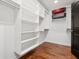 A bright walk-in closet with custom shelves and hardwood floors at 1302 Ladd St, Atlanta, GA 30310