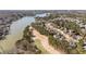 An aerial view of a residential neighborhood, houses, golf course and lake in a wooded area at 2250 Blackheath Trce, Alpharetta, GA 30005