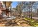Brick home features a backyard with a spiral staircase leading to a stone patio and lush forest views at 2250 Blackheath Trce, Alpharetta, GA 30005