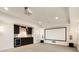Basement offers a movie screen, speakers, and dark-stained wet bar with a wine fridge at 2250 Blackheath Trce, Alpharetta, GA 30005