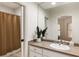 Bathroom features a vanity with sink, plant, and a shower with a curtain at 2250 Blackheath Trce, Alpharetta, GA 30005