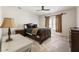 Cozy bedroom with a ceiling fan, wooden furniture, carpeted floor and ample lighting at 2250 Blackheath Trce, Alpharetta, GA 30005