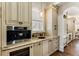 Convenient butler pantry with a sink, stainless coffee machine, and wine cooler at 2250 Blackheath Trce, Alpharetta, GA 30005