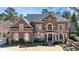 Stately brick home with manicured lawn and mature landscaping at 2250 Blackheath Trce, Alpharetta, GA 30005