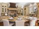 Spacious gourmet kitchen with large granite island and countertops, modern appliances, and custom cabinetry at 2250 Blackheath Trce, Alpharetta, GA 30005
