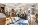 Open-concept living area with staircase, fireplace, and hardwood floors, seamlessly connected to the kitchen and dining space at 2250 Blackheath Trce, Alpharetta, GA 30005