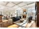 Open-concept living room with fireplace, coffered ceiling, and large windows at 2250 Blackheath Trce, Alpharetta, GA 30005