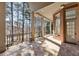 Brick patio with decorative columns and railings overlooks a wooded backyard at 2250 Blackheath Trce, Alpharetta, GA 30005