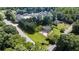 Expansive aerial view of a home featuring a lush green lawn, mature trees, and a neighborhood setting at 3500 Thunderwood Ln, Snellville, GA 30039