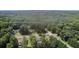 A serene aerial shot of a home surrounded by dense trees, highlighting its peaceful, secluded location at 3500 Thunderwood Ln, Snellville, GA 30039