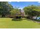 Scenic backyard view showcasing a wooden deck, lush lawn, and mature trees at 3500 Thunderwood Ln, Snellville, GA 30039