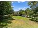 Lush backyard view with a deck, landscaping, and a glimpse of the home's rear exterior at 3500 Thunderwood Ln, Snellville, GA 30039