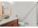 Bathroom featuring a single sink vanity, toilet, and partially visible shower stall at 3500 Thunderwood Ln, Snellville, GA 30039
