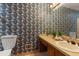 Bathroom featuring patterned wallpaper, a single sink vanity, toilet and mirror at 3500 Thunderwood Ln, Snellville, GA 30039