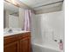 Bathroom featuring a shower with purple curtain, oak cabinets, and a mirror at 3500 Thunderwood Ln, Snellville, GA 30039