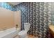 Bathroom features patterned wallpaper, a combination tub/shower and a single sink vanity at 3500 Thunderwood Ln, Snellville, GA 30039