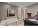 Bathroom featuring tiled tub, shower, and double sink vanity at 3500 Thunderwood Ln, Snellville, GA 30039