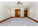 Bright bedroom with carpeting, baseboard trim, closet and door frames made of wood at 3500 Thunderwood Ln, Snellville, GA 30039