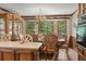 Dining room featuring large windows, wood cabinetry, and ornate table set at 3500 Thunderwood Ln, Snellville, GA 30039
