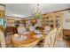 Elegant dining room with ornate table, chandelier, and wood cabinetry at 3500 Thunderwood Ln, Snellville, GA 30039